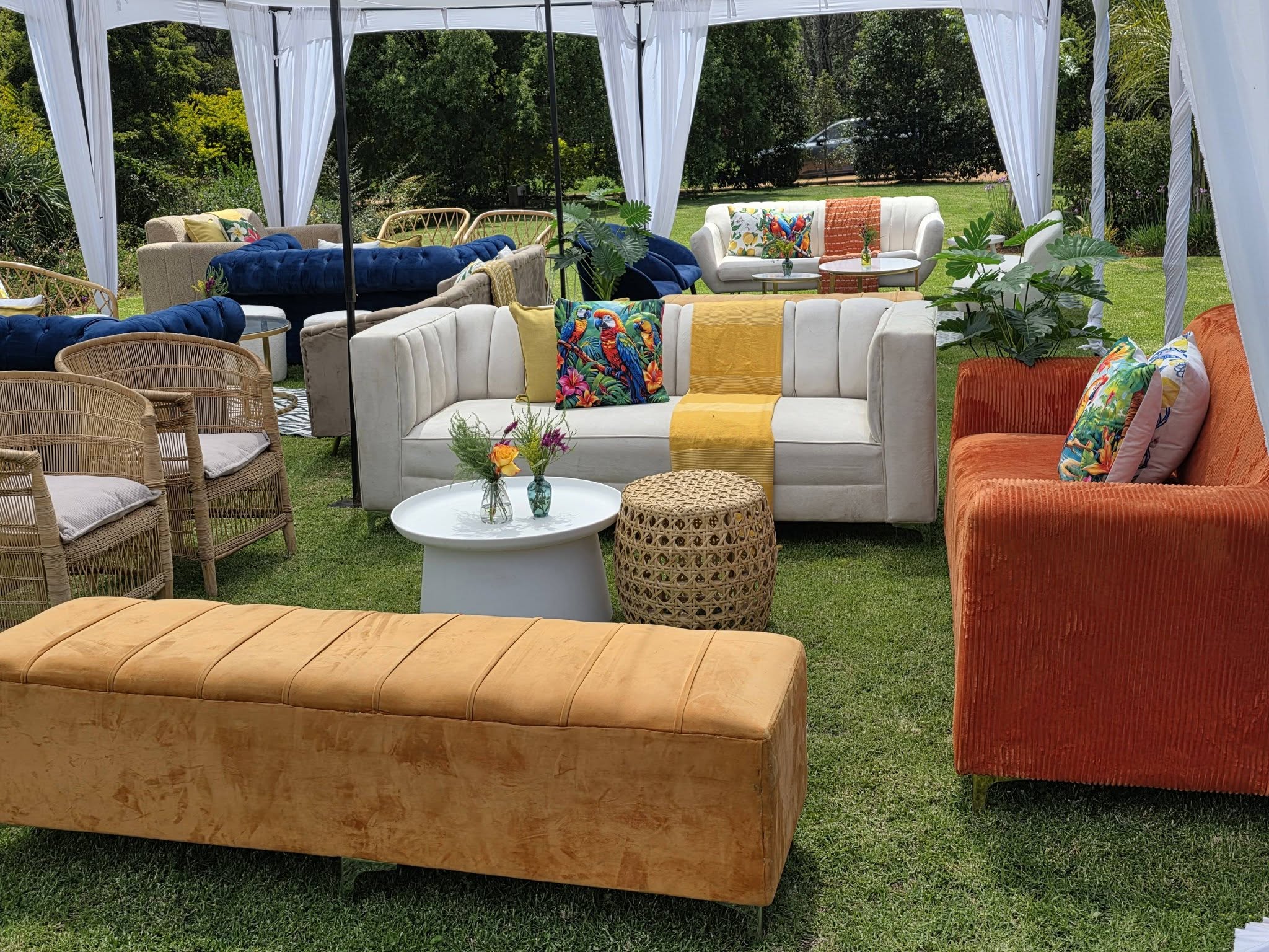 60th birthday garden lounge at Muano with velvet sofas and marquee tent on manicured lawn